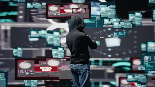 Man uses virtual reality headset for system corruption and password cracking, cyber intelligence define this tech driven theft. Intrusion and threat alerts reveal dangerous hacking. Camera B.
