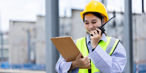 Engineer is working at high voltage power substation conducting inspection and check of...