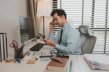 an entrepreneur is feeling stressed while sitting at his office, a businessman is overworked and is...