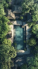 High-angle view of a tranquil pool nestled amidst lush greenery and traditional-style buildings