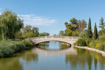 serene landscape of astrakhan featuring beautiful bridge over calm waters surrounded by lush greenery and clear