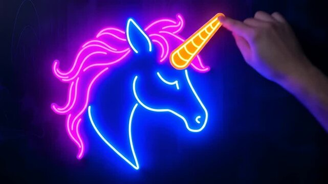 A Hand Touches The Horn Of A Vibrant Glowing Neon Unicorn Sign Against A Dark Backdrop