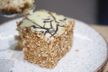 Delicious dessert with nut coating served on a plate
