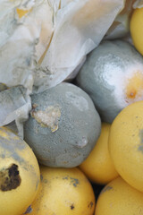 Fresh fruits with some decay in a market setting