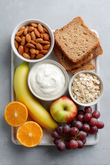 colorful assortment of healthy snacks for children including fruits nuts and wholegrain options arranged neatly on