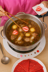 "Cooking Hot Pot with Fresh Ingredients"
