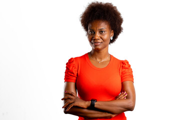 Young black woman with arms crossed, looks at camera on studio white background