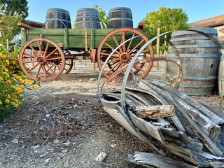 A side view captures an old wagon with a broken wooden barrel prominently in the foreground, highlighting rustic historical elements in Rancho Cucamonga, CA.