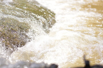 A serene river flows powerfully through a lush, waters cascading down a mountain slope,Red flood water flows from the mountains, Nature of forests and red streams formed by the previous heavy rain