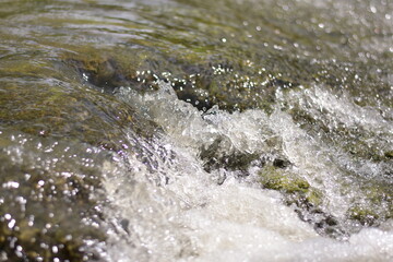 A serene river flows powerfully through a lush, waters cascading down a mountain slope,Red flood water flows from the mountains, Nature of forests and red streams formed by the previous heavy rain