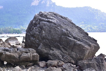 waves crashing on rocks, Rocks and trees on the coast, sea with rocks and sand. Travel photo