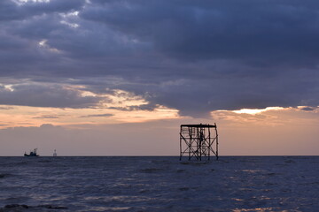 The sea and evening light with rain clouds,  sun and clouds, Evening sunset over the sea during the tropical monsoon rain season
