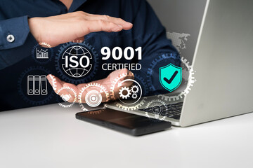 ISO 9001 certified quality management system concept with digital icons and business process on laptop screen