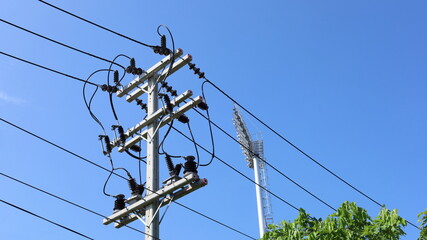 Electric wires on poles. High-voltage electric wires with fuses to prevent backflow of energy to...