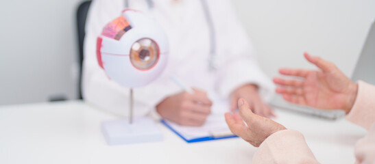 Elderly Patient consulting Doctor to Eye disease, Senior Medical Diagnosis. Anatomy Eye model for...