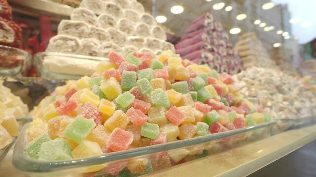 Colorful sweets displayed in market near busy street