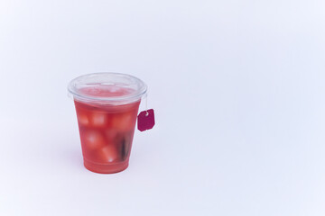 Relaxing concept iced herbal tea in take away cup on white background.