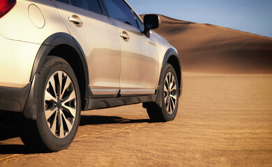  Silver vehicle seen from behind on a dusty Namibian road, blending modern design with rugged desert terrain. Ideal for travel, automotive, and editorial themes. 