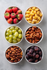 colorful assortment of healthy snacks for children including fruits nuts and wholegrain options arranged neatly on