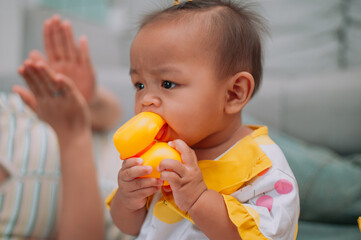 Portrait of Toddler girl is playing with toys in a cozy living room at home.