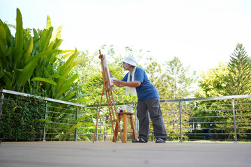 Happy Senior Asian Woman Painting Outdoors, Happy Elderly Female Artist Enjoying Nature, Creative...