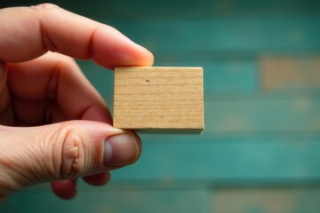 Close-up of hand holding single wooden block, smooth surface, simple, success, object