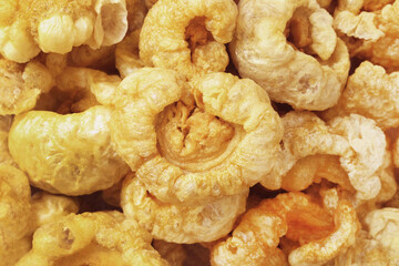 Closeup of pork snack or pork rinds, deep fried pork skin and blistered is traditional food in the north of Thailand.
