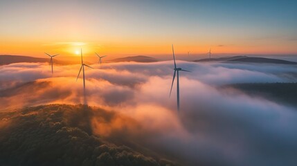 Obraz premium Wind Turbines Rising Above the Morning Mist at Golden Sunrise, Environmental Power