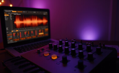 Creative Home Studio: MIDI Controller and Laptop with Orange Audio Waveform in Moody Purple Light