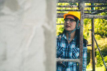 Young female project manager supervising construction work at residential building project.