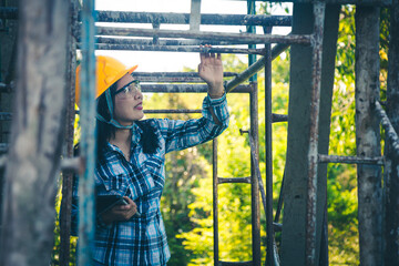 Young female project manager supervising construction work at residential building project.