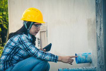 Female engineer ensuring safety standards during housing project site visit.