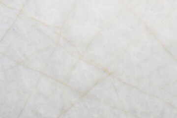 A close up shot displaying a white marble surface with subtle beige veining running throughout the stone