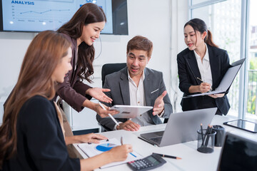 Group of Asian business people standing in a meeting, on the table there are documents, graphs, calculators, meeting for investment, business.