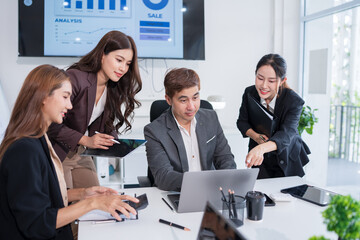 Group of Asian business people standing in a meeting, on the table there are documents, graphs, calculators, meeting for investment, business.