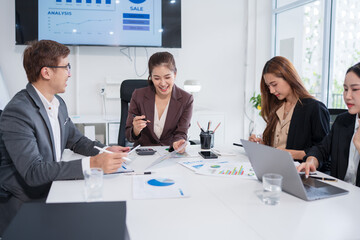 Team of Asian doctors and businesspeople are meeting in a hospital conference room.
