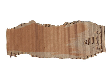Torn cardboard piece with rough edges  visible corrugated layers resting on a textured gray surface