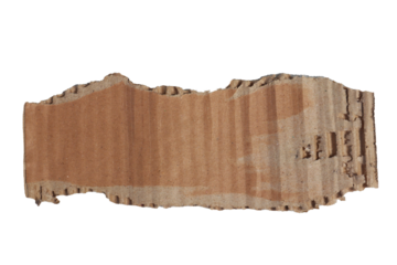 Torn cardboard piece with rough edges  visible corrugated layers resting on a textured gray surface