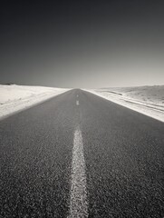 A straight road in the middle of magnificent sand dunes, dramatic photo, simple line drawing, symmetrical composition, at dusk, master of landscape photography, film emulsion fading effect