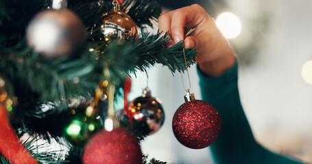 Person, hand and christmas tree with bauble for decor, festive event or december holiday in home....