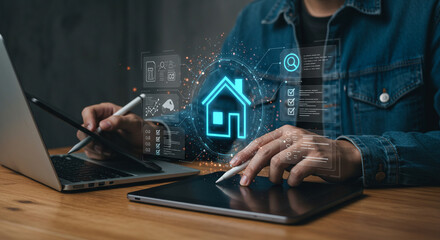 Person using laptop and tablet with digital house icon and interface overlays on a wooden desk top business.selling ,purchasing,agreement 