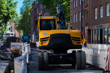 Heavy machinery working on urban construction site in daylight