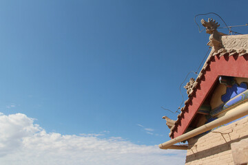 Ancient Chinese architecture roof with flying eaves and carved dragon head at Jiayu Pass in summer, Jiayuguan in Gansu Province of China