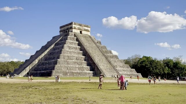 Visitors explore the iconic El Castillo pyramid at Chichen Itza, a World Heritage Site and ancient Mayan temple in Mexico.