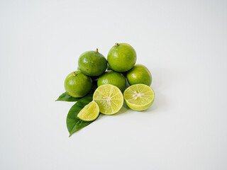 Natural cluster of limes and sliced wedges for farm-to-table concepts and Southeast Asian produce content in high-resolution food photography