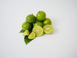 Clean overhead view of whole lime and wedges positioned with subtle shadow and crisp detail for commercial and editorial food design