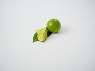 Single lime with leaves creating a natural botanical frame and centered layout 