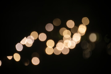 Blurred lights, soft glow, dark background.