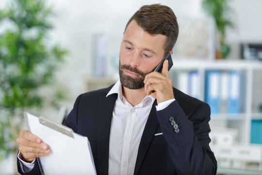 real estate agent using mobile phone at new home