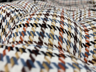 Closeup detail of colorful checkered plaid fabric texture background.